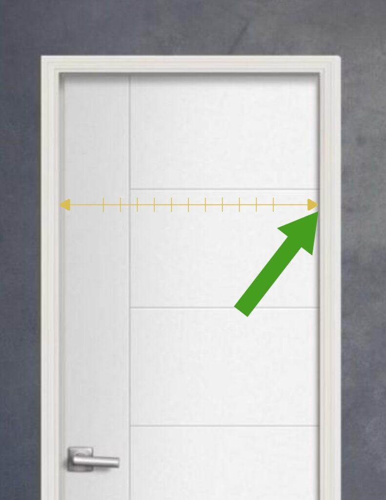 Using a tape measure to determine the interior door thickness